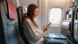passenger using smartphone on plane